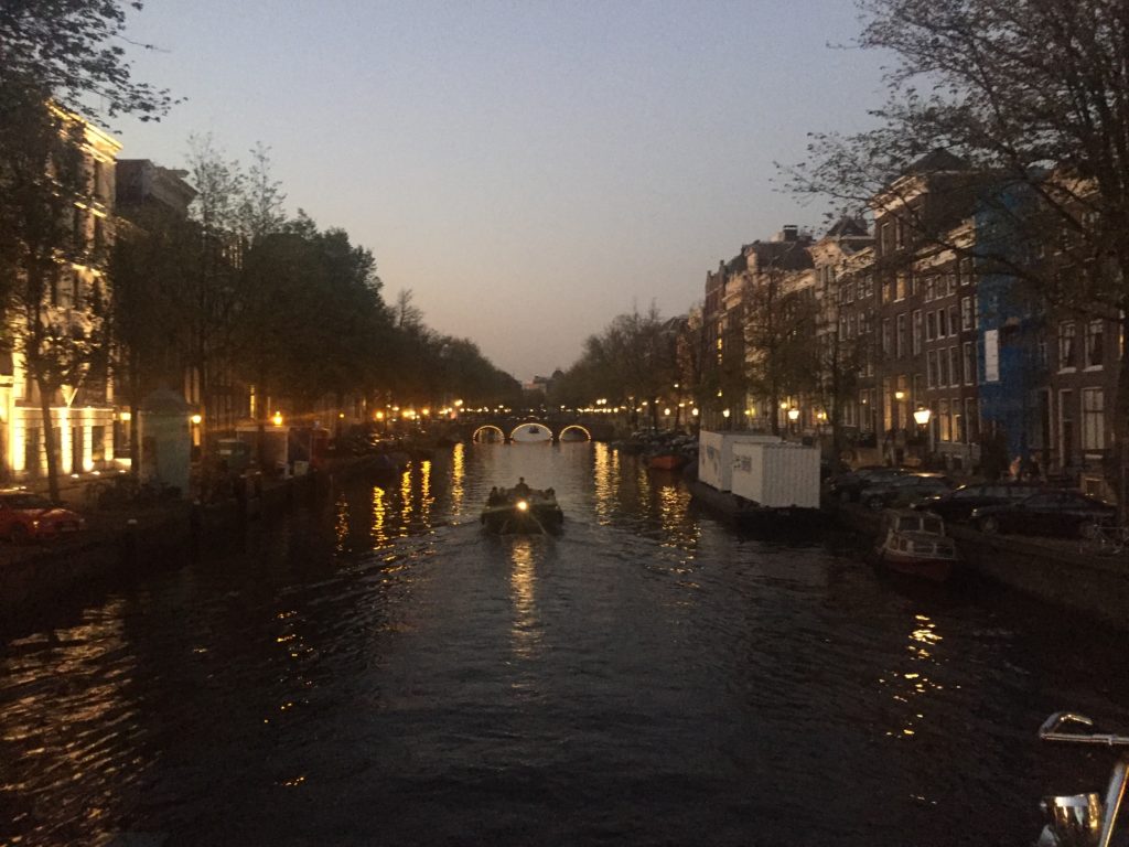 Amsterdam canal lit up at night